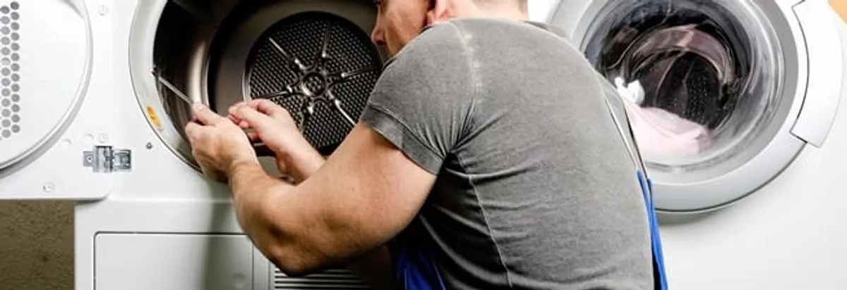 Dryer repair technician fixing a clothes dryer drum in Duluth, MN