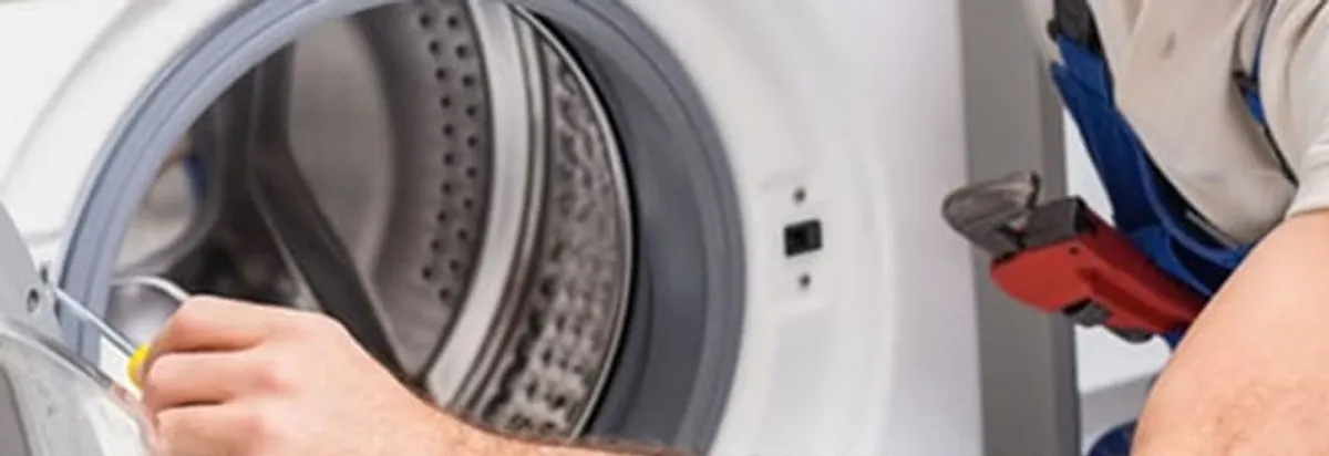 Appliance technician repairing a clothes dryer drum and internal parts in Duluth, MN